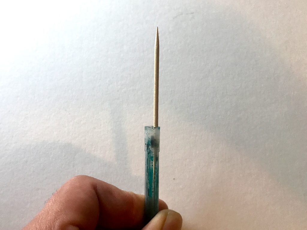 Use a toothpick/paperclip to swivel the stopper